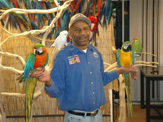 Parrots for Patriots founder Chris Driggins with some of the birds up for adoption